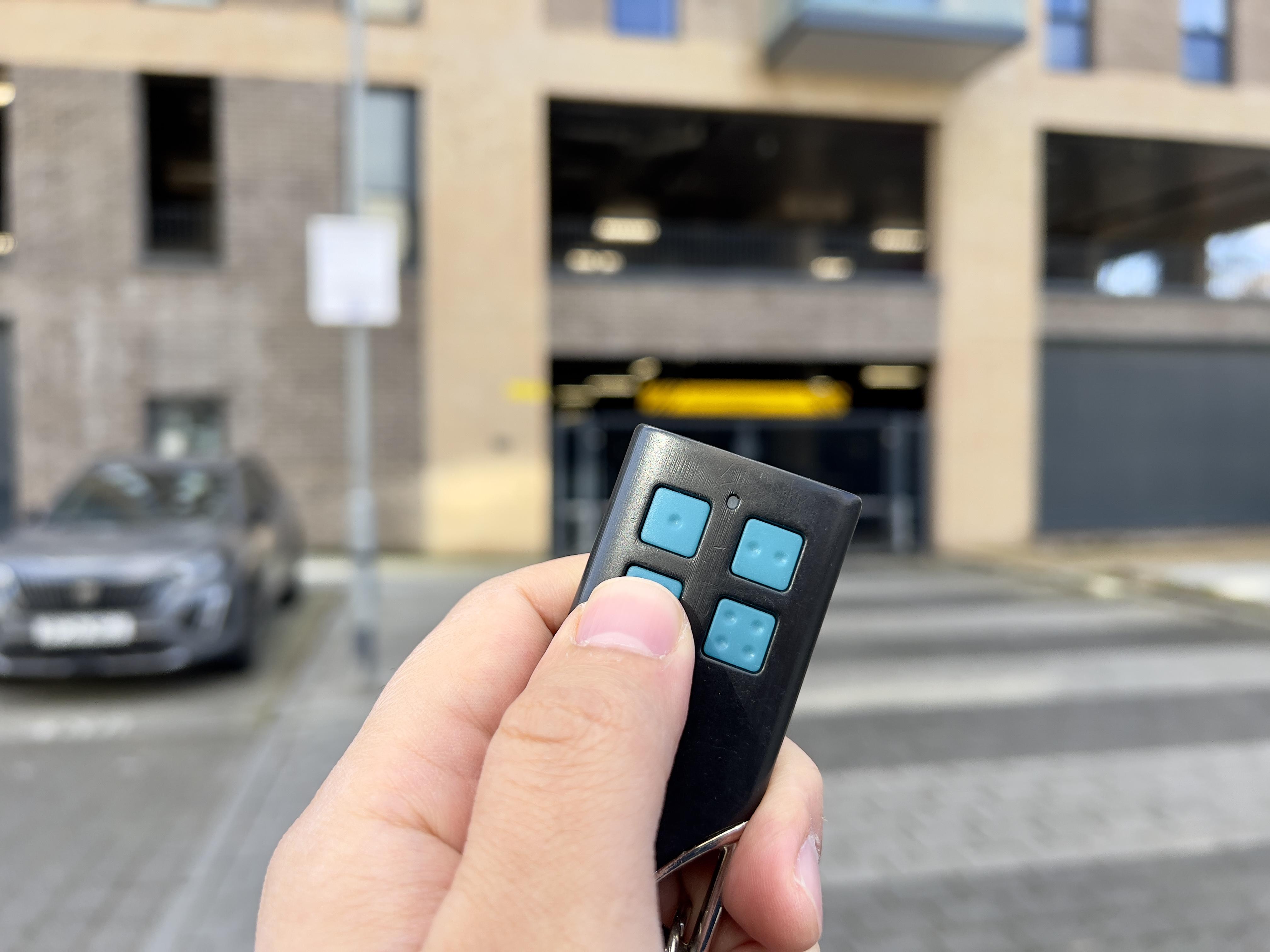You will need to press 3 dotted button on the fob to open the gate